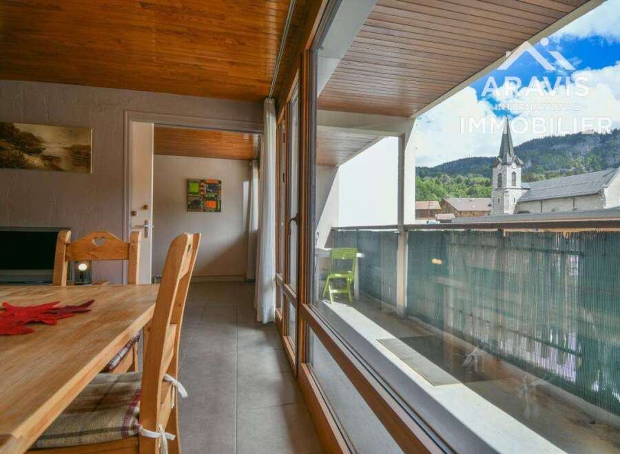 Discover a charming property with stunning views! This home features a cozy dining area with a wooden table and chairs, perfect for enjoying meals.