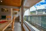 Discover a charming property with stunning views! This home features a cozy dining area with a wooden table and chairs, perfect for enjoying meals.