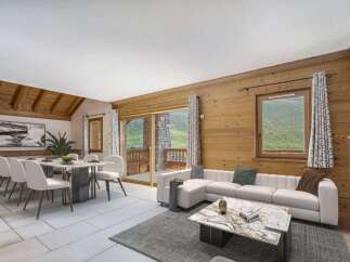 Experience luxury living in this stunning property, featuring a spacious living area with a modern white sofa and a cozy fireplace.
