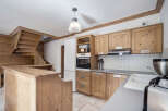 This charming kitchen boasts a rustic design with wooden cabinetry and a cozy atmosphere.