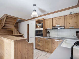 This charming kitchen boasts a rustic design with wooden cabinetry and a cozy atmosphere.