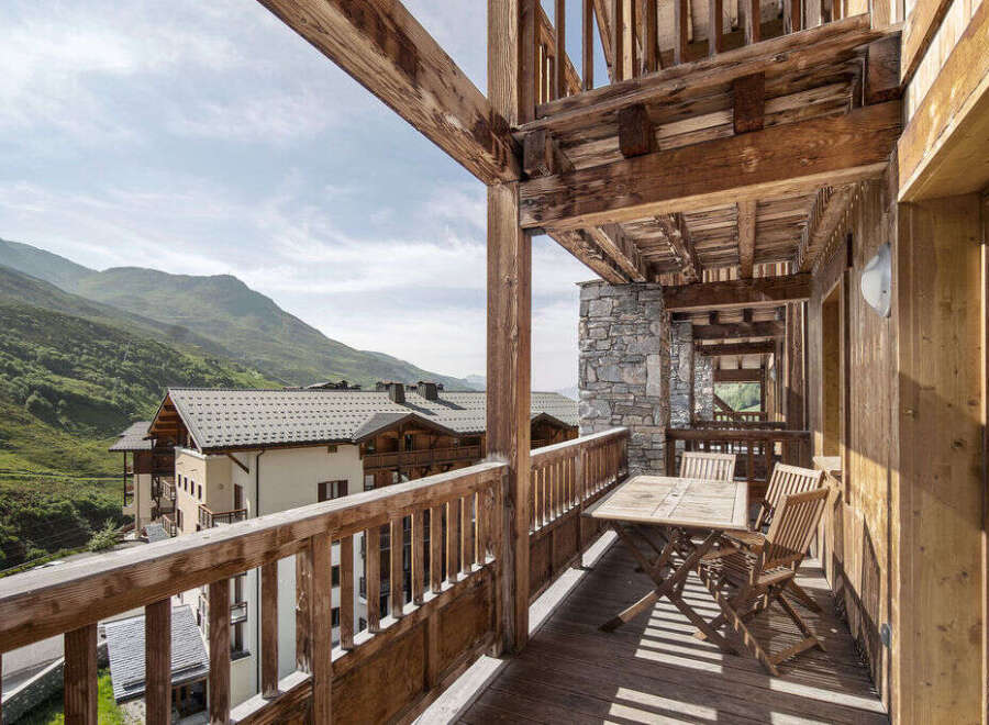 Experience the charm of this stunning property with its inviting balcony, offering breathtaking views of the surrounding mountains.