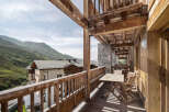 Experience the charm of this stunning property with its inviting balcony, offering breathtaking views of the surrounding mountains.