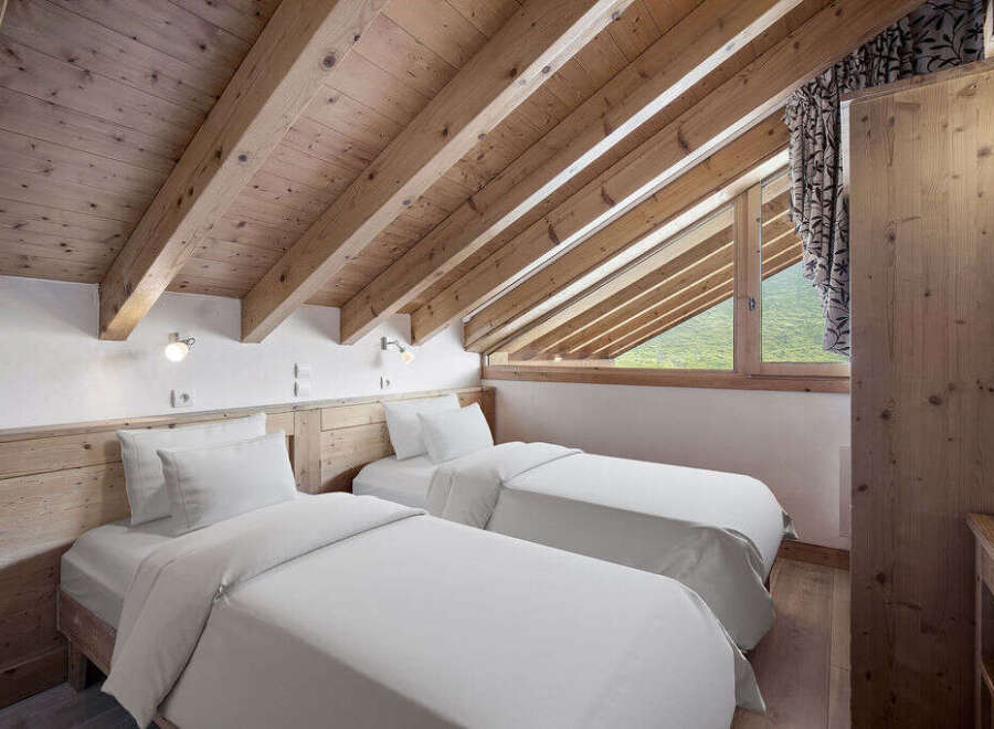 Discover the charm of this cozy bedroom featuring two comfortable beds, perfect for a relaxing stay.