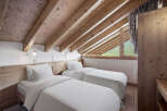 Discover the charm of this cozy bedroom featuring two comfortable beds, perfect for a relaxing stay.