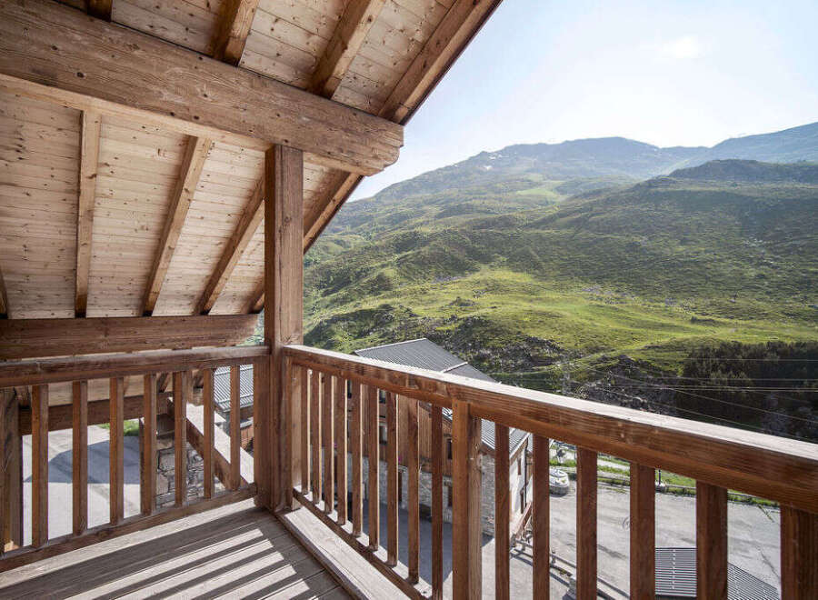 Enjoy breathtaking mountain views from this stunning wooden balcony.