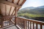 Enjoy breathtaking mountain views from this stunning wooden balcony.