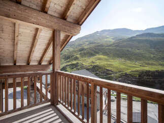 Enjoy breathtaking mountain views from this stunning wooden balcony.