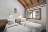 Discover the charm of this cozy bedroom featuring two comfortable twin beds, perfect for a relaxing stay.