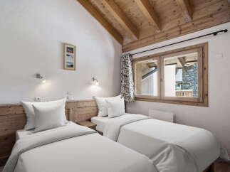 Discover the charm of this cozy bedroom featuring two comfortable twin beds, perfect for a relaxing stay.