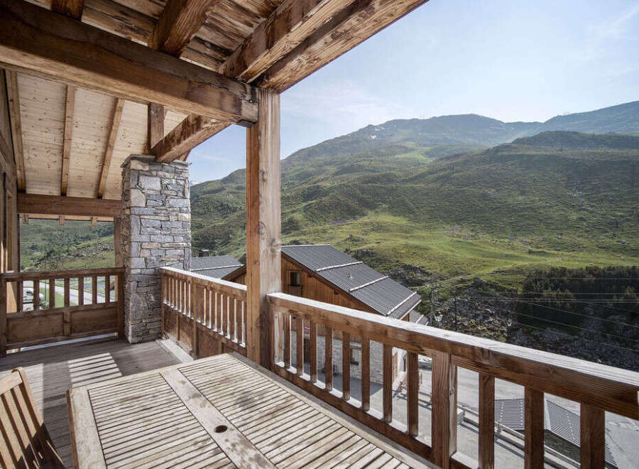 Enjoy breathtaking mountain views from this stunning chalet balcony.