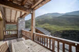 Enjoy breathtaking mountain views from this stunning chalet balcony.