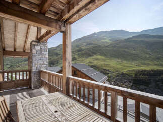 Enjoy breathtaking mountain views from this stunning chalet balcony.