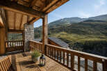 Experience breathtaking mountain views from this stunning wooden balcony, perfect for enjoying your morning coffee or evening relaxation.
