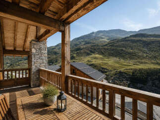 Experience breathtaking mountain views from this stunning wooden balcony, perfect for enjoying your morning coffee or evening relaxation.