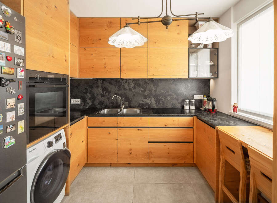 This stunning kitchen boasts custom wooden cabinetry, offering ample storage and a warm, inviting atmosphere.