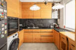 This stunning kitchen boasts custom wooden cabinetry, offering ample storage and a warm, inviting atmosphere.