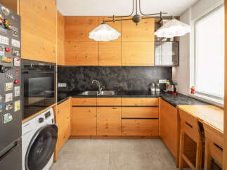 This stunning kitchen boasts custom wooden cabinetry, offering ample storage and a warm, inviting atmosphere.