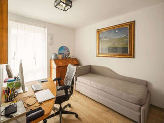 This inviting home office offers a blend of comfort and functionality.
