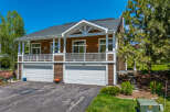 Discover this stunning property featuring a charming two-story house with a welcoming porch and a two-car garage.
