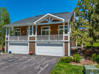 Discover this stunning property featuring a charming two-story house with a welcoming porch and a two-car garage.