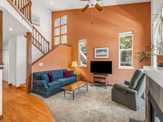 This inviting living room boasts a cozy ambiance with its plush blue sofa and a comfortable recliner, perfect for relaxing.