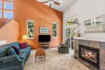 Step into this inviting living room, featuring a cozy fireplace and a comfortable seating area.