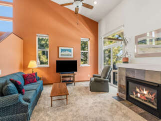 Step into this inviting living room, featuring a cozy fireplace and a comfortable seating area.