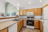 Step into this inviting kitchen, featuring warm wooden cabinetry and ample counter space.