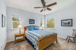 This inviting bedroom features a comfortable bed with a stylish blue and white striped comforter, perfect for a relaxing retreat.