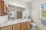 This inviting bathroom features a double vanity with ample counter space, perfect for shared use.