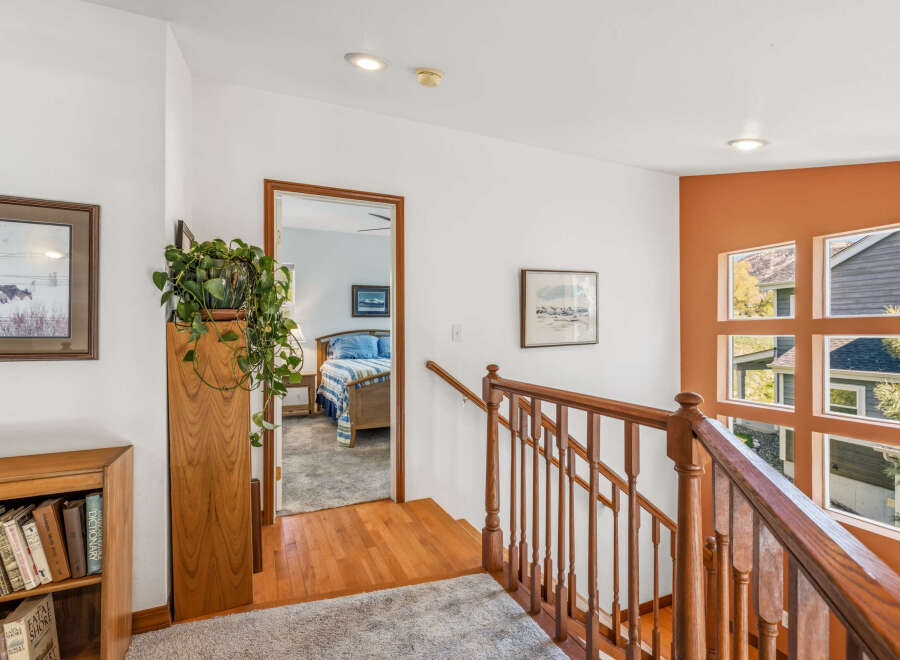 This inviting home features a warm and welcoming interior with hardwood floors and a cozy staircase.
