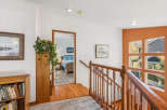 This inviting home features a warm and welcoming interior with hardwood floors and a cozy staircase.