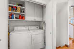 This laundry room offers convenience and functionality with its modern appliances and ample storage.