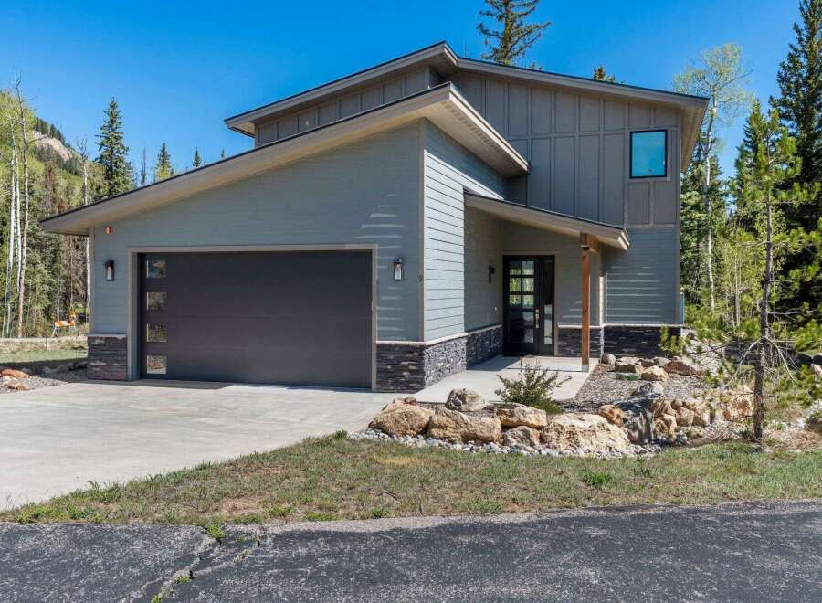 This stunning modern home boasts a sleek design and inviting curb appeal.