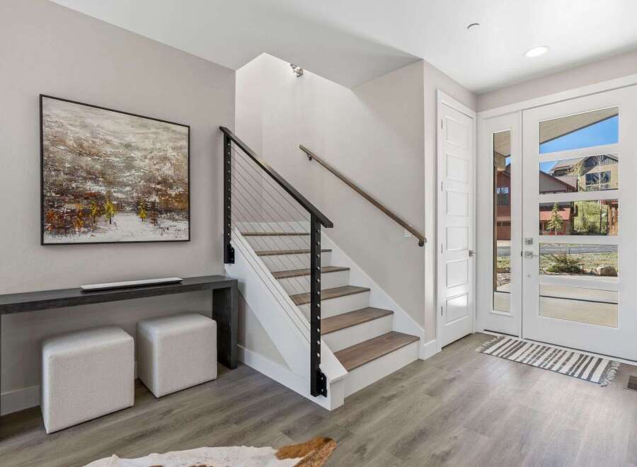 Step into modern elegance with this stunning property! Featuring a sleek staircase with a contemporary cable railing, this home exudes sophistication.