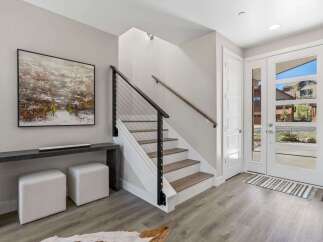 Step into modern elegance with this stunning property! Featuring a sleek staircase with a contemporary cable railing, this home exudes sophistication.