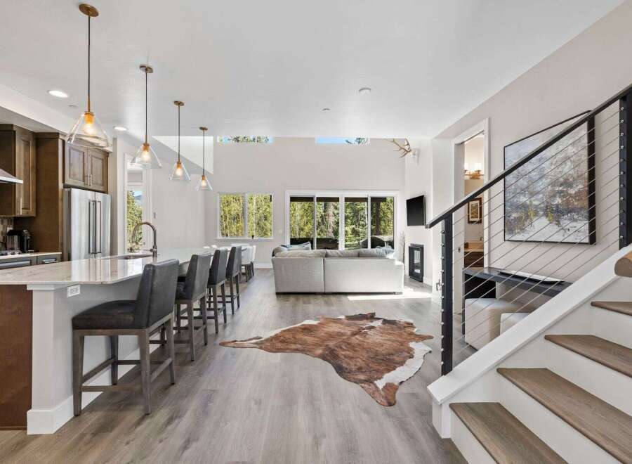 Step into luxury with this stunning property, boasting a modern kitchen with a spacious island and sleek bar seating.