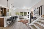 Step into luxury with this stunning property, boasting a modern kitchen with a spacious island and sleek bar seating.