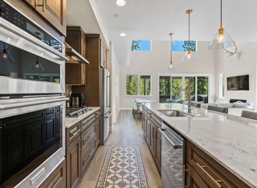 Step into luxury with this stunning kitchen! Featuring stainless steel appliances, a spacious island, and elegant cabinetry, this kitchen is a chef's dream.