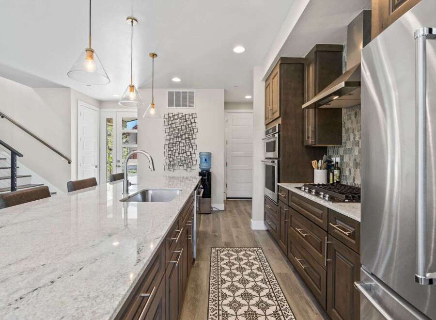 This stunning kitchen boasts a modern design with sleek cabinetry and a spacious island, perfect for culinary enthusiasts.