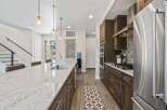 This stunning kitchen boasts a modern design with sleek cabinetry and a spacious island, perfect for culinary enthusiasts.