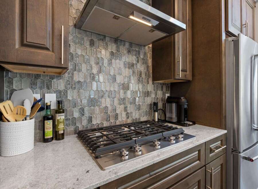 This stunning kitchen boasts modern design and high-end appliances.