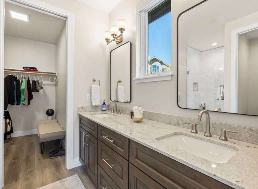 This stunning bathroom boasts a modern design with a double vanity and sleek fixtures.