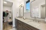 This stunning bathroom boasts a modern design with a double vanity and sleek fixtures.