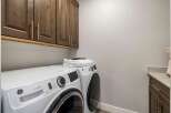 Discover the convenience of this well-appointed laundry room, featuring modern appliances and ample storage.