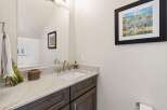 This stunning bathroom features a modern design with a sleek vanity and a beautiful granite countertop.