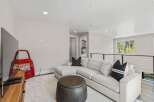 This stunning property boasts a modern living space with a comfortable sectional sofa and stylish accent pillows.