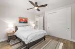 Step into this inviting bedroom, featuring a cozy bed and a stylish rug.