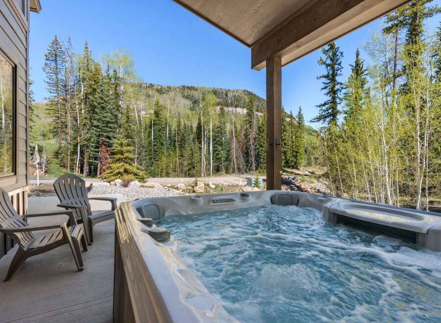 Relax and unwind in this stunning property featuring a luxurious hot tub, perfect for enjoying the breathtaking mountain views.
